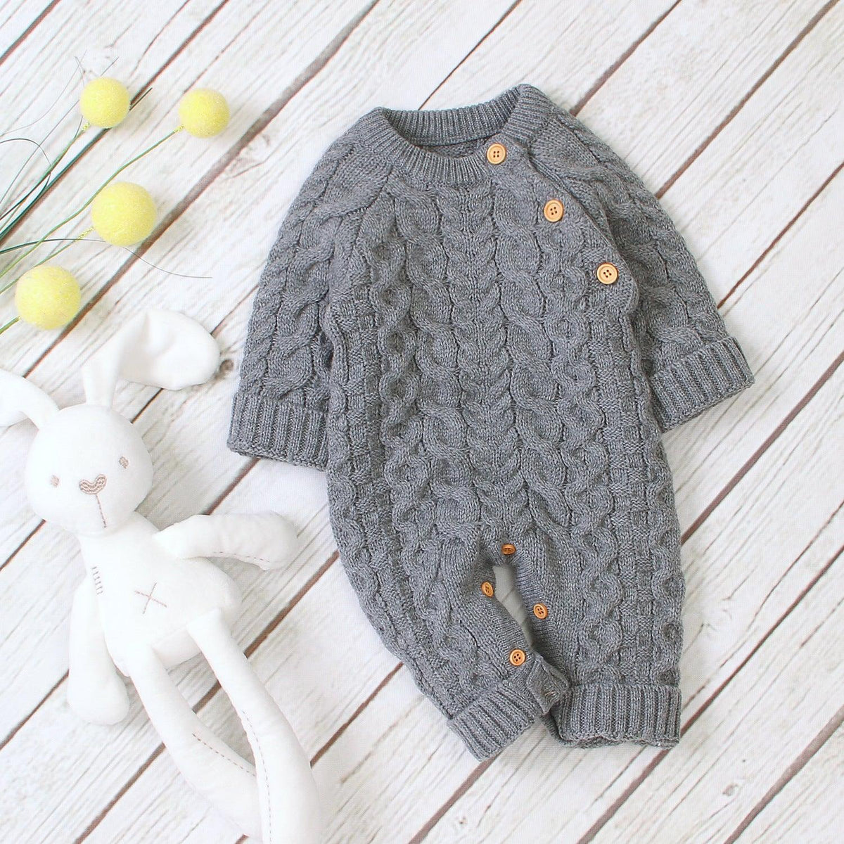 Combinaison pour bébé en tricot de couleur unie